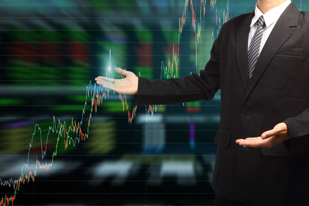 42077173 – business man hand holding with stock market graph background