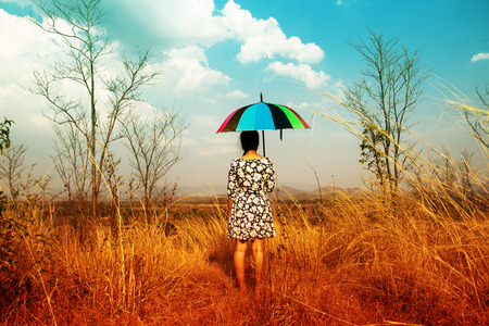 75810210 – woman with umbrella on the mountain